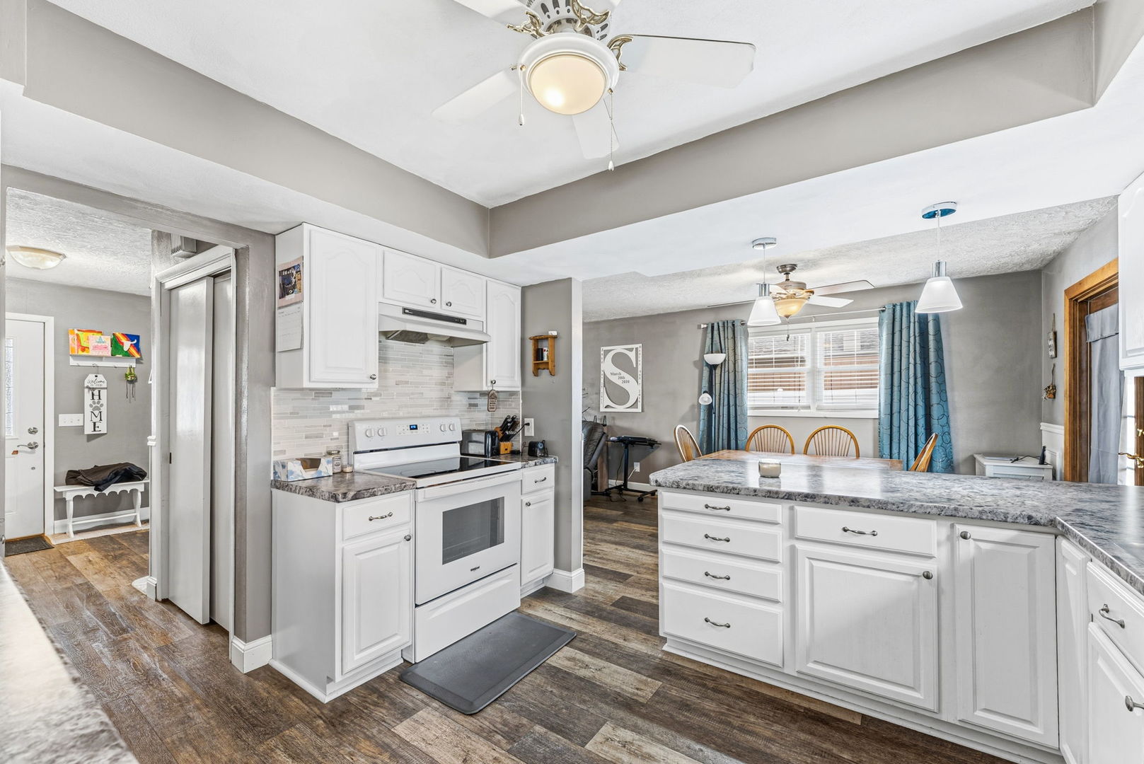 404 Southwest 10th Street Aledo, IL 61231 - Photo 12 of 27 a kitchen with white cabinets and stainless steel appliances