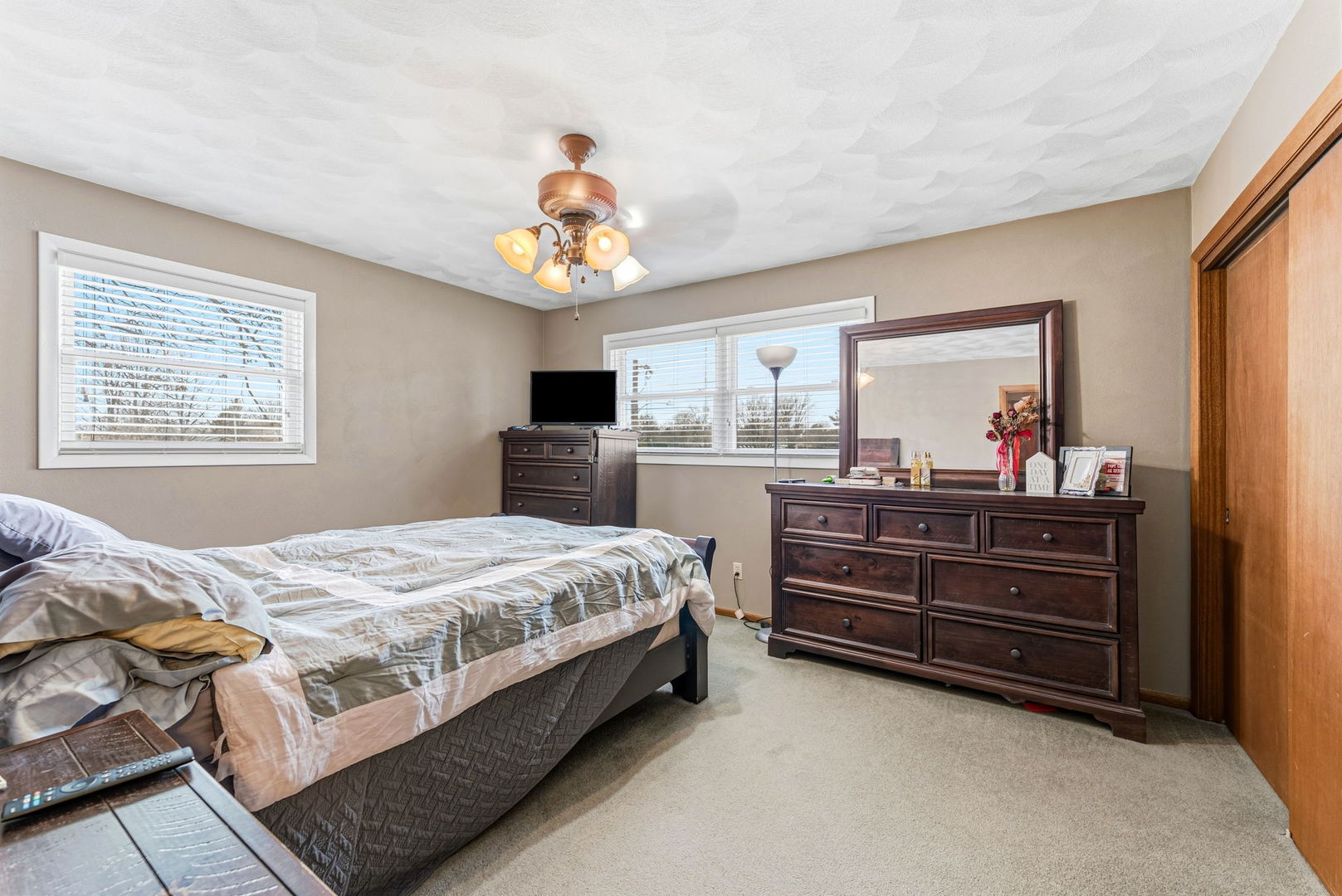 404 Southwest 10th Street Aledo, IL 61231 - Photo 15 of 27 a bedroom with a bed and a chandelier