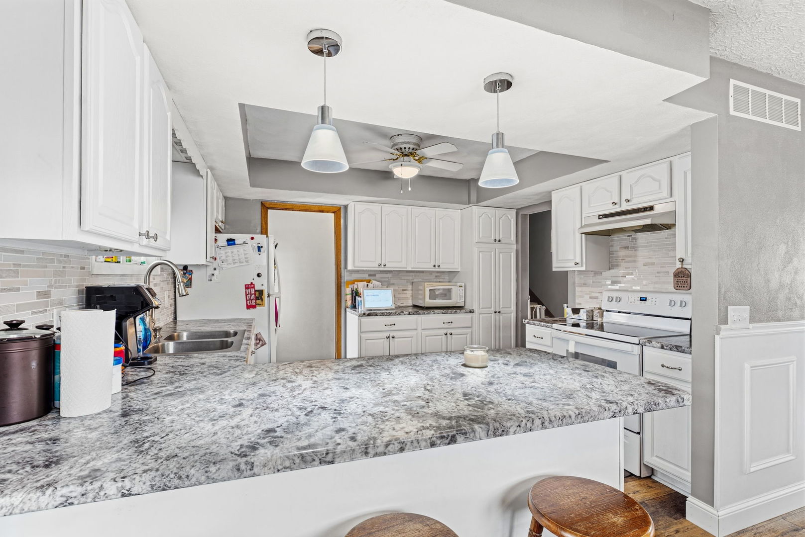 404 Southwest 10th Street Aledo, IL 61231 - Photo 10 of 27 a kitchen with stainless steel appliances granite countertop a sink refrigerator and cabinets
