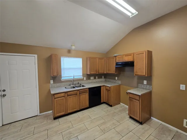 a kitchen with a sink and cabinets