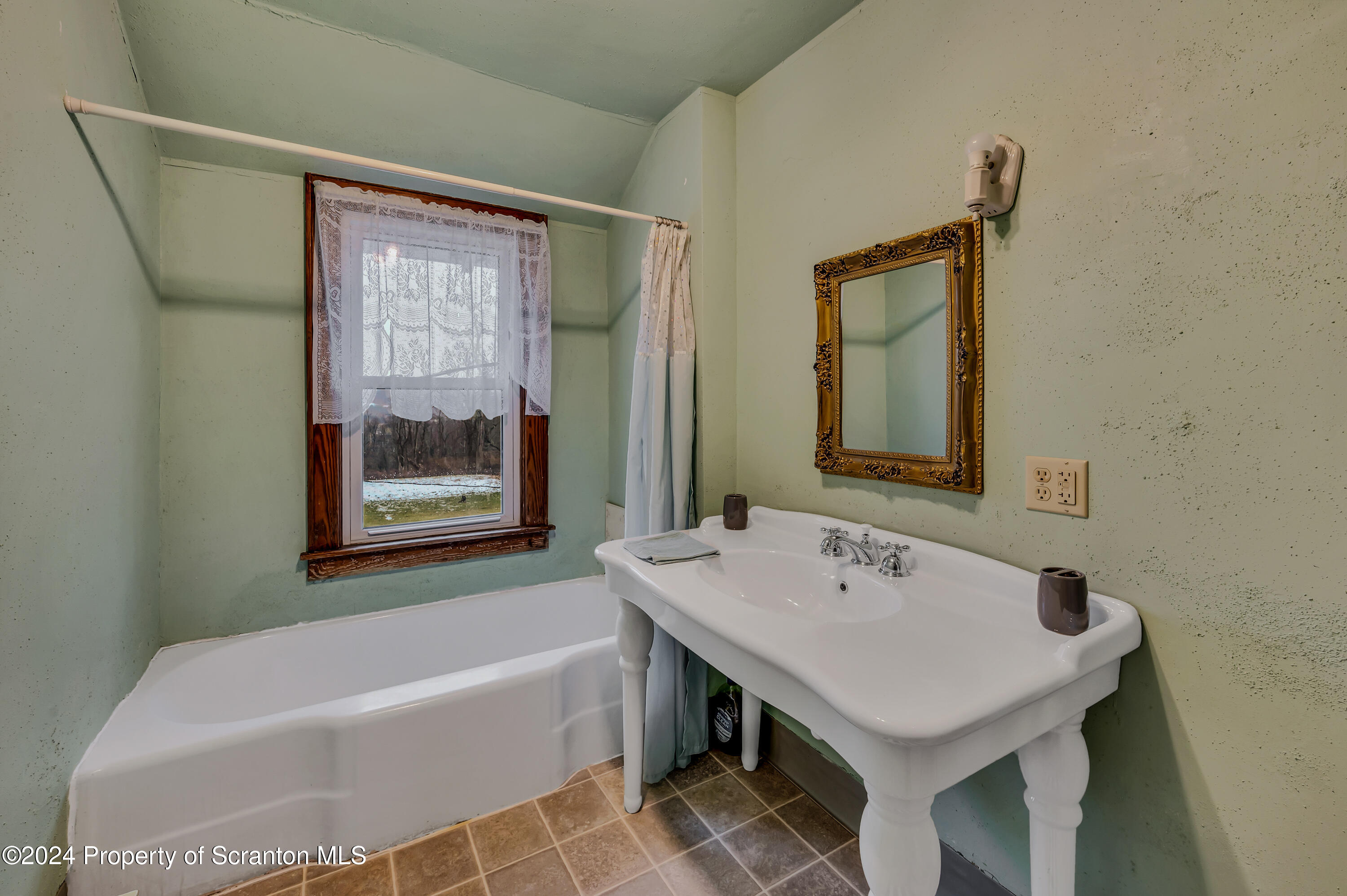 1128 County Home Road Montrose, PA 18801 - Photo 28 of 68 a bathroom with a sink and a bathtub