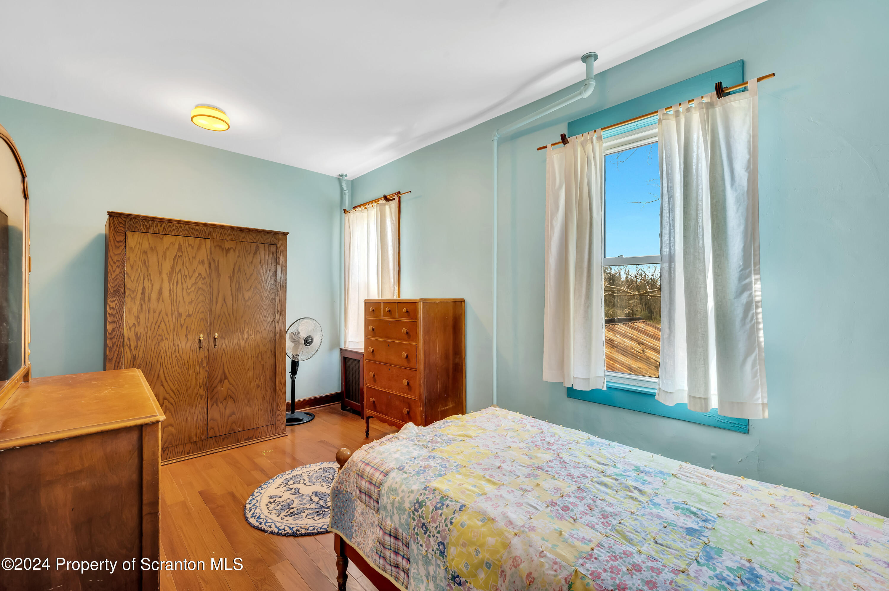 1128 County Home Road Montrose, PA 18801 - Photo 37 of 68 a bedroom with a bed and wooden floor