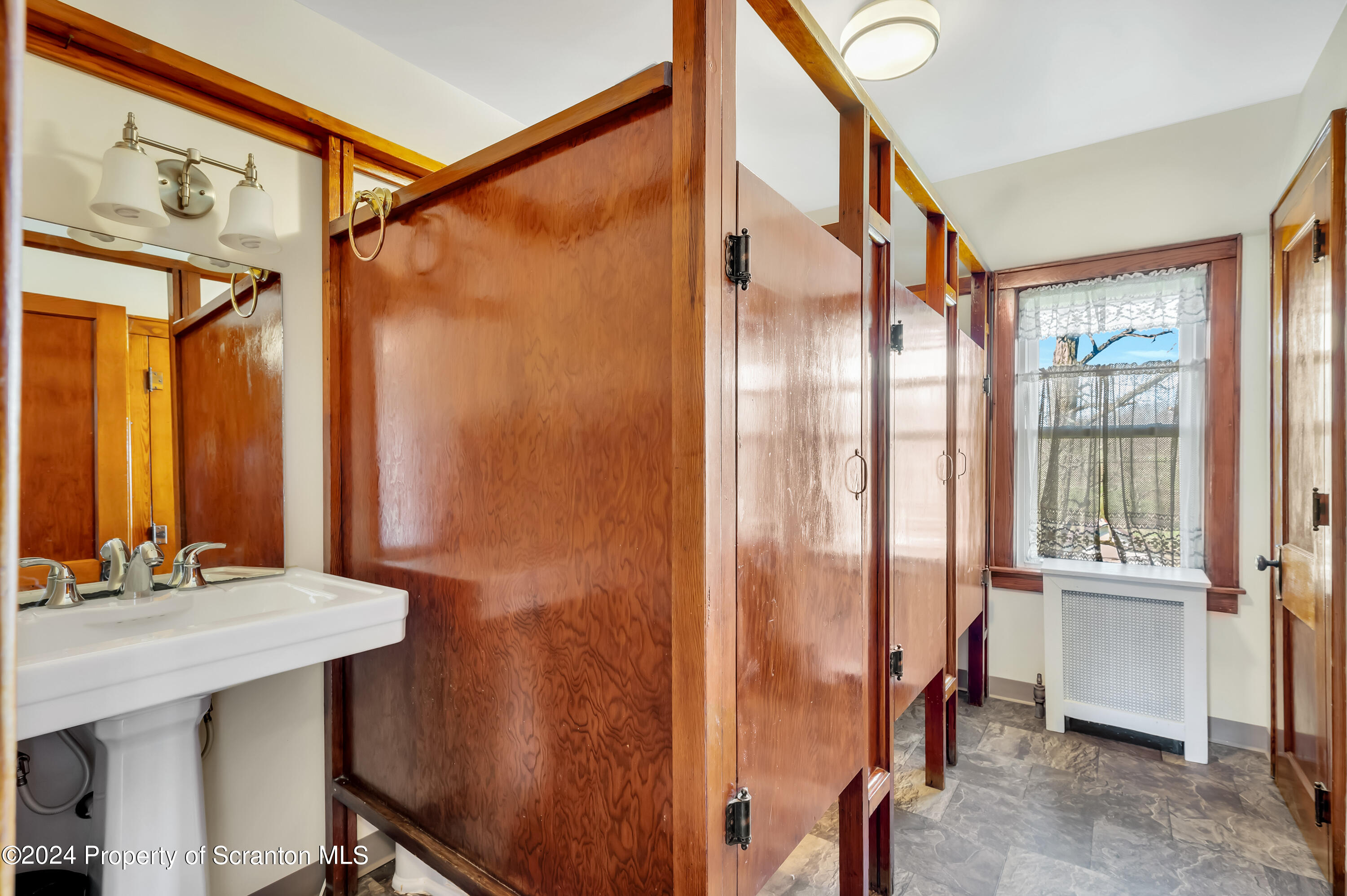 1128 County Home Road Montrose, PA 18801 - Photo 41 of 68 a bathroom with a granite countertop sink a mirror and a shower