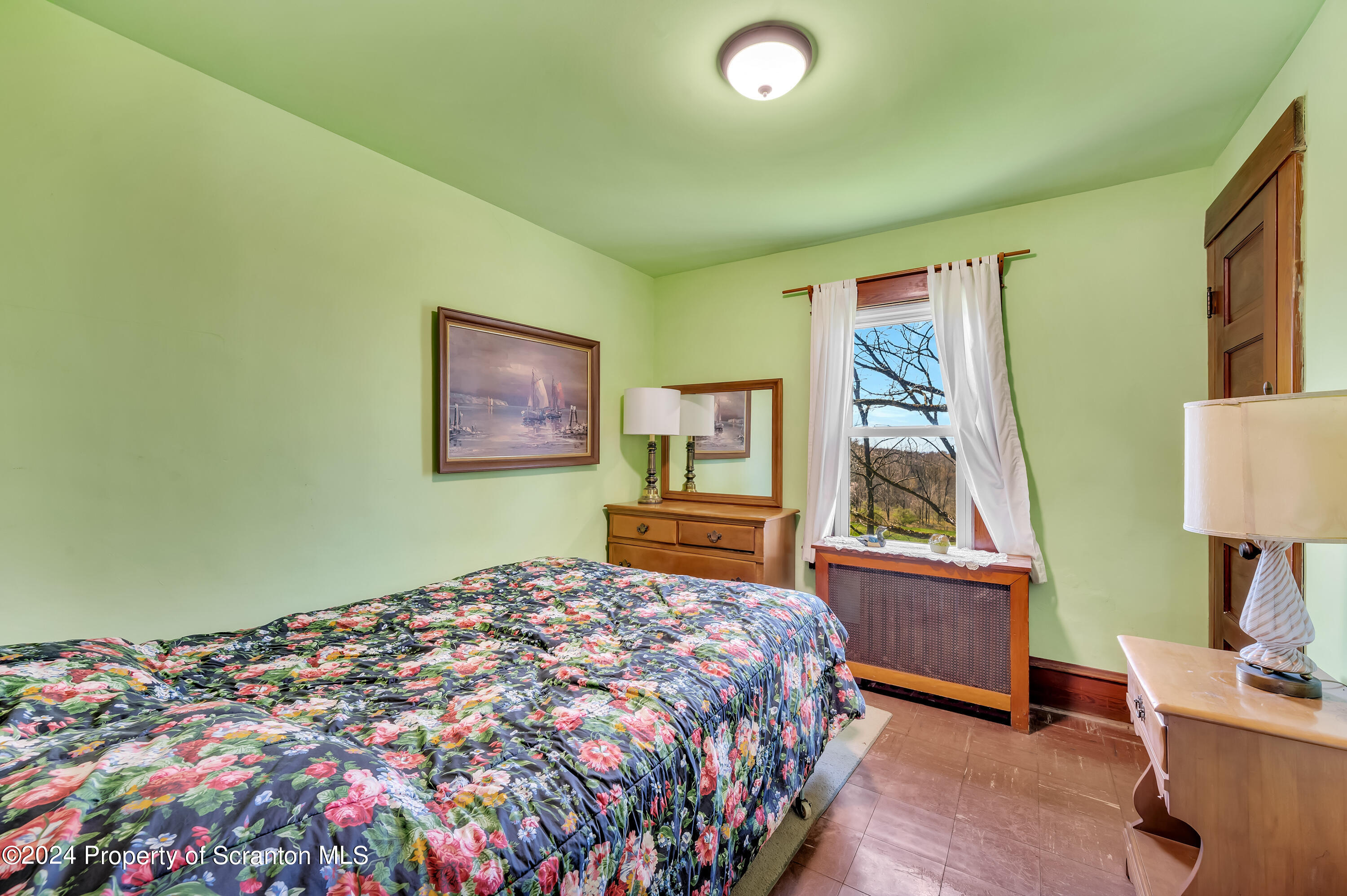 1128 County Home Road Montrose, PA 18801 - Photo 44 of 68 a bedroom with a bed and wooden floor