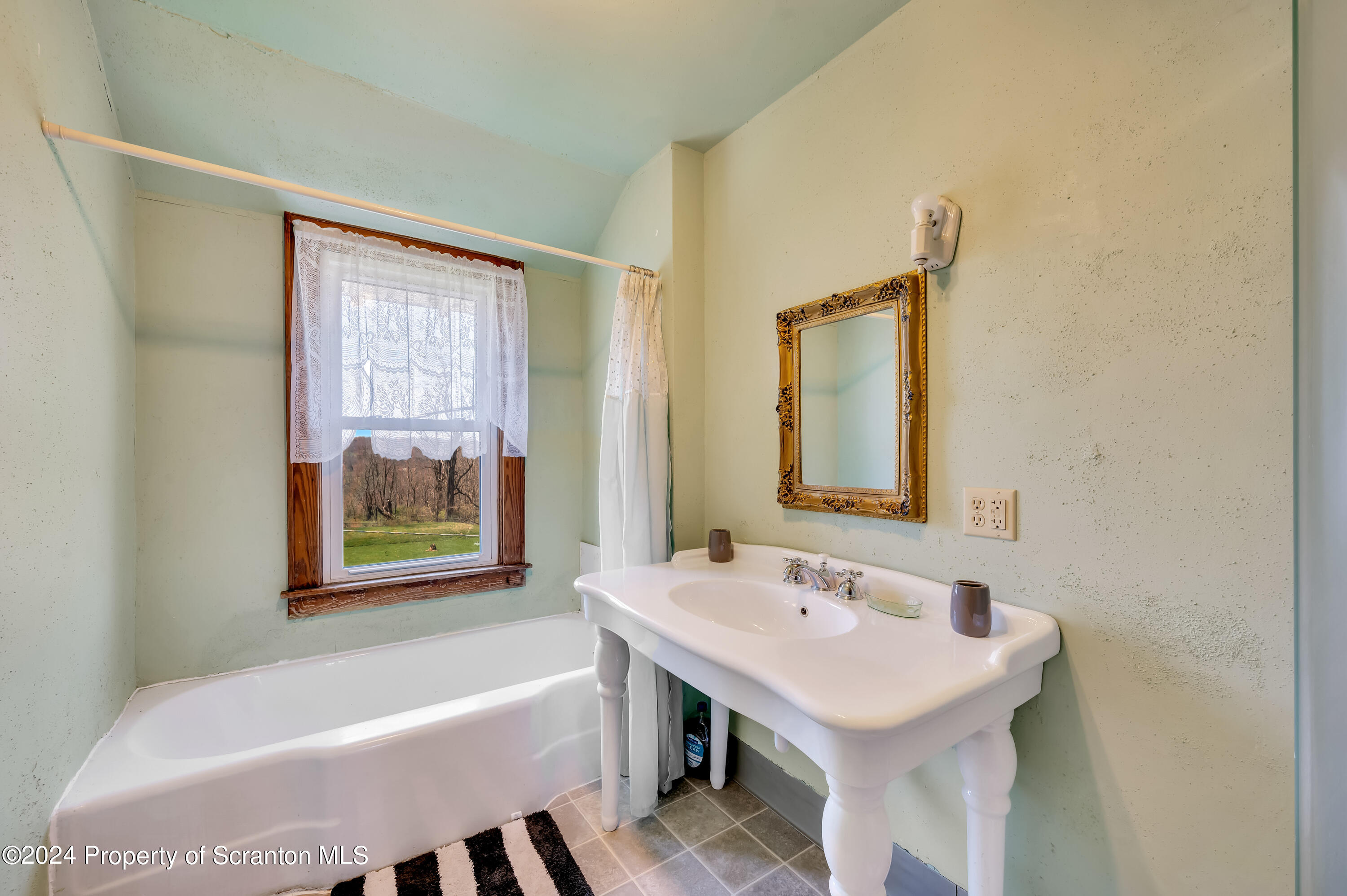 1128 County Home Road Montrose, PA 18801 - Photo 45 of 68 a bathroom with a sink and a bathtub