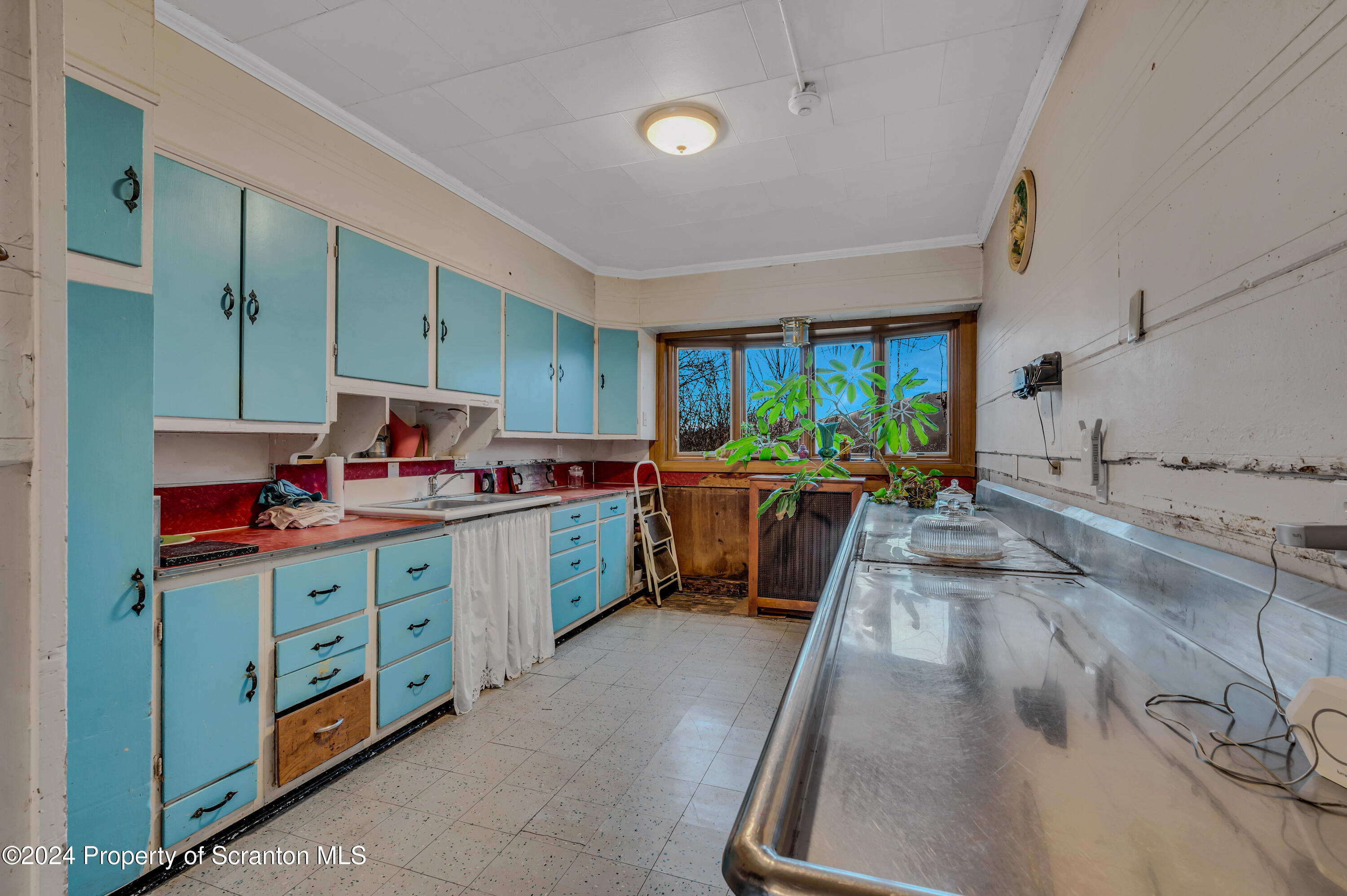 1128 County Home Road Montrose, PA 18801 - Photo 8 of 68 a kitchen with stainless steel appliances kitchen island granite countertop a stove a sink dishwasher and cabinets with wooden floor