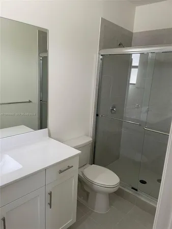 a bathroom with a shower and a toilet