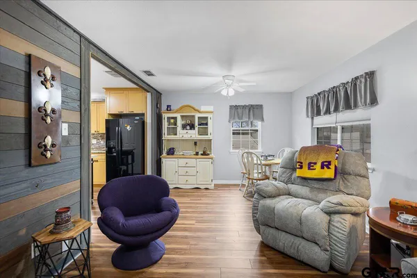 a living room with furniture and a book shelf