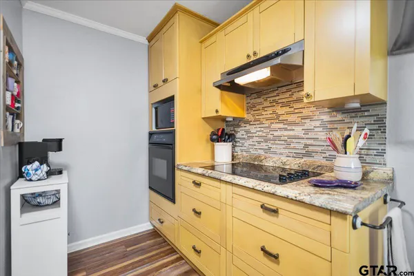 a kitchen with stainless steel appliances granite countertop a stove and a refrigerator