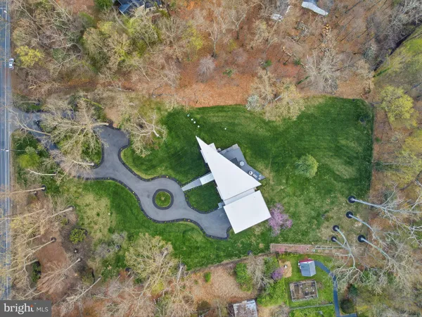 an aerial view of a house with a yard