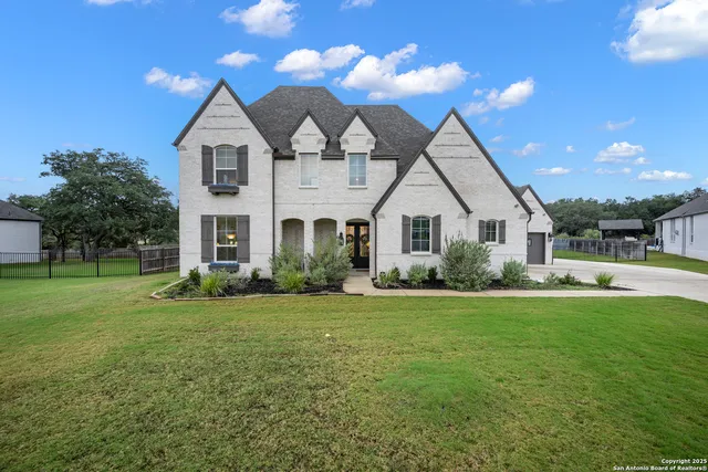 a front view of a house with a yard and porch