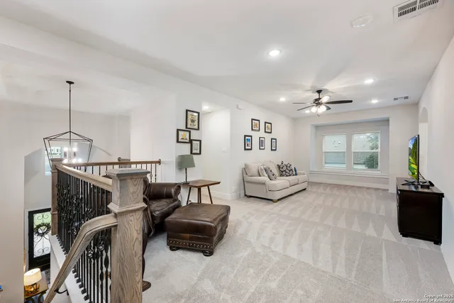 a bed room with furniture and a flat screen tv