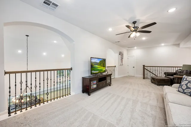 a bedroom that has a bed a dresser and a flat tv screen on the dresser