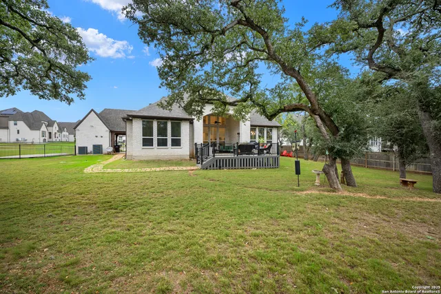 a front view of a house with a yard and trees