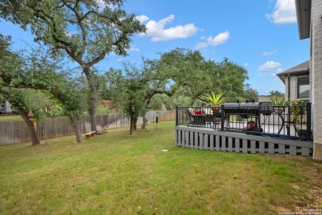 a swimming pool with some trees in the background