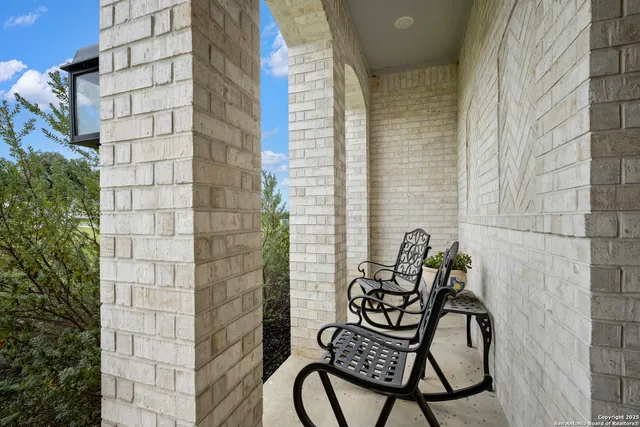 a balcony with table and chairs