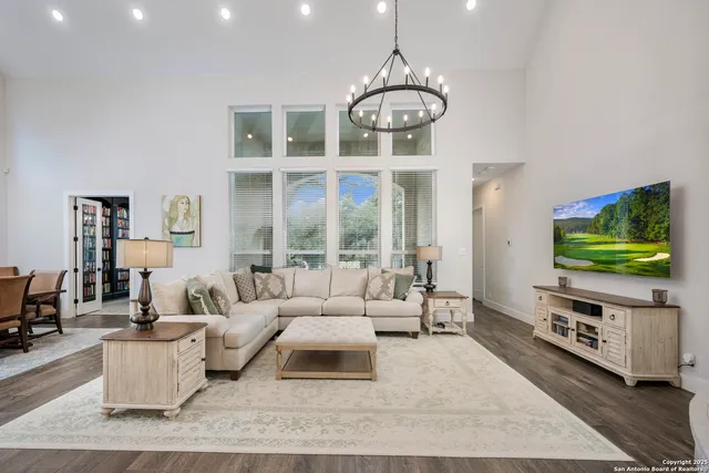 a living room with furniture flat screen tv and couches