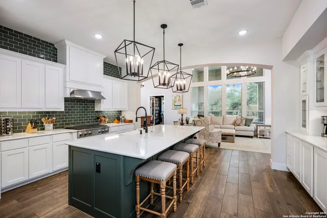 a kitchen with sink cabinets and wooden floor