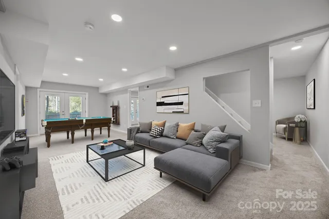 a living room with furniture a rug and white walls