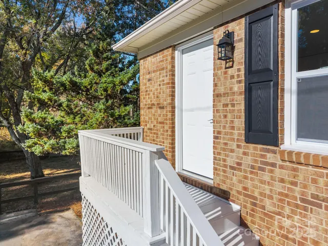 a view of a balcony with wooden floor and fence