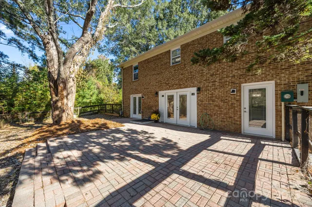 a view of a backyard with a large tree