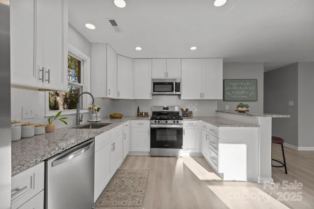 a kitchen with a sink stove top oven and refrigerator