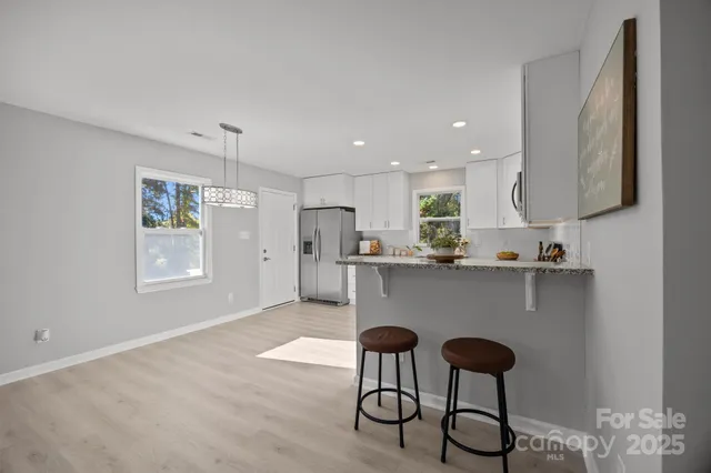 a kitchen with stainless steel appliances granite countertop a sink and a refrigerator