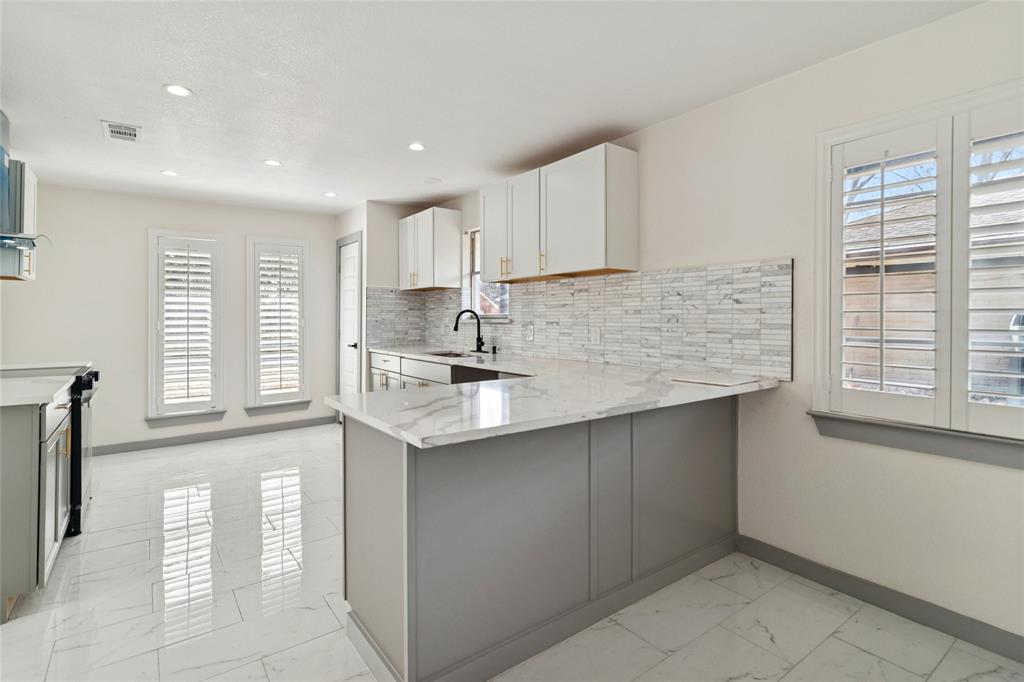 2325 Regal Road Plano, TX 75075 - Photo 12 of 34 a kitchen with stainless steel appliances granite countertop a sink and a stove top oven