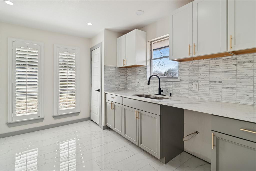 2325 Regal Road Plano, TX 75075 - Photo 13 of 34 a kitchen with stainless steel appliances granite countertop a sink and a stove