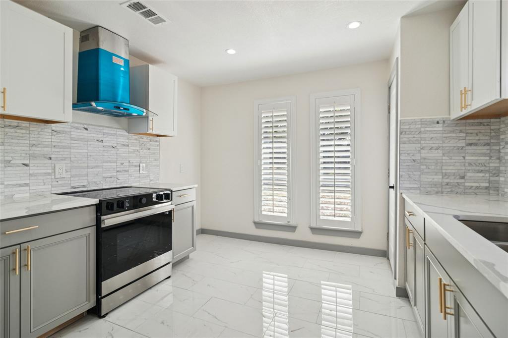 2325 Regal Road Plano, TX 75075 - Photo 14 of 34 a kitchen with a stove and a sink