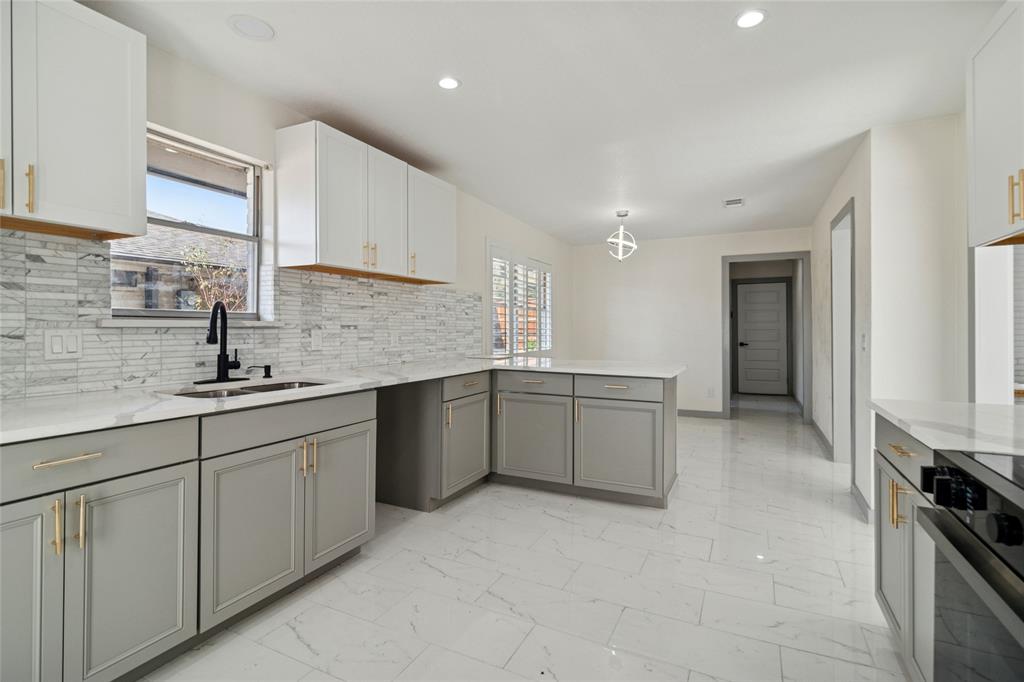 2325 Regal Road Plano, TX 75075 - Photo 15 of 34 a large kitchen with stainless steel appliances granite countertop a sink and cabinets