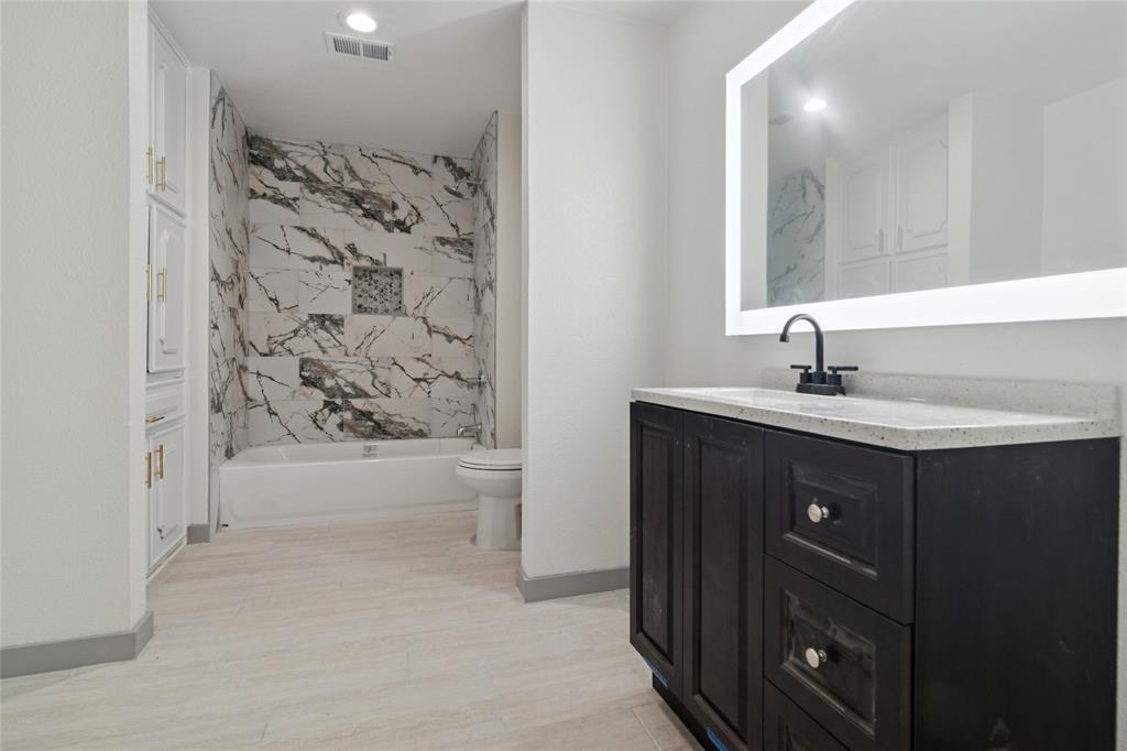 2325 Regal Road Plano, TX 75075 - Photo 25 of 34 a bathroom with a sink a bathtub and a shower