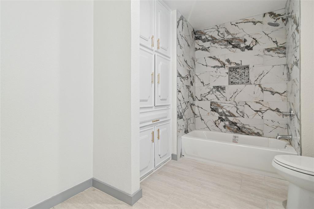 2325 Regal Road Plano, TX 75075 - Photo 26 of 34 a bathroom with a bathtub and shower