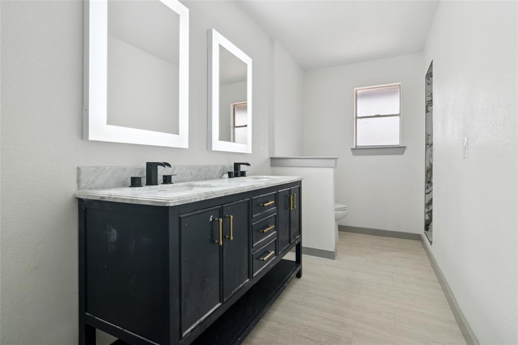 2325 Regal Road Plano, TX 75075 - Photo 30 of 34 a bathroom with a double vanity sink and mirror