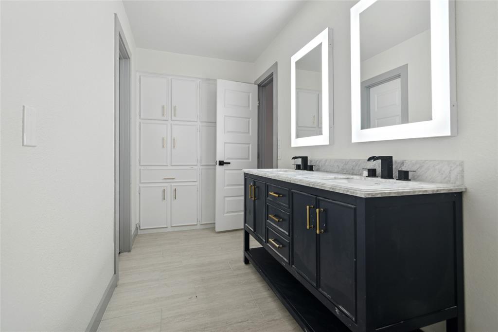 2325 Regal Road Plano, TX 75075 - Photo 31 of 34 a kitchen with a sink vanity and a mirror