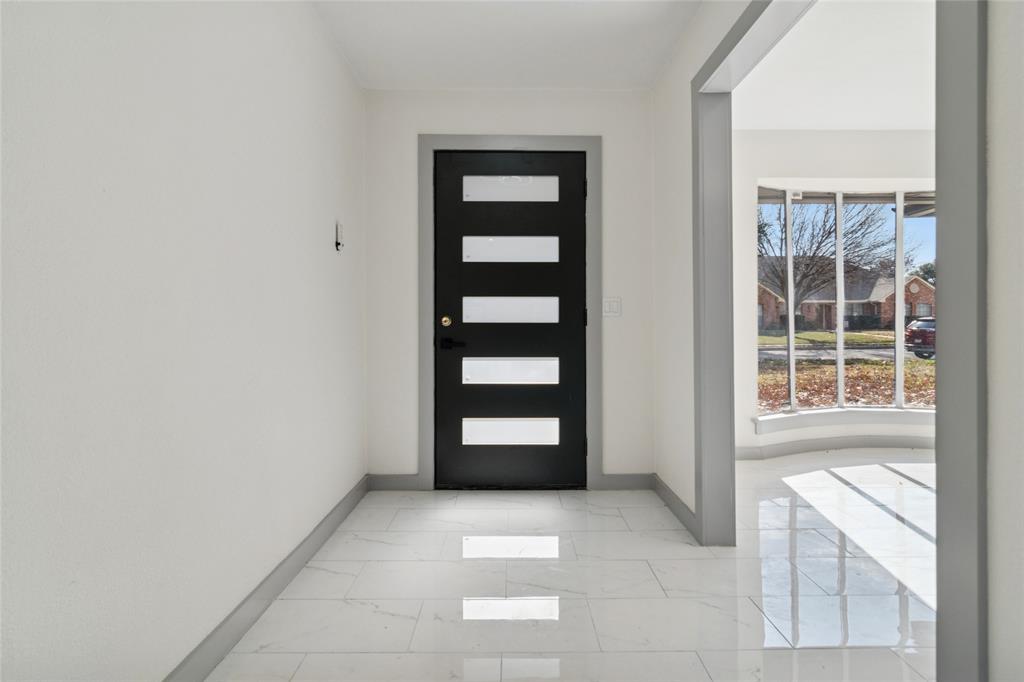 2325 Regal Road Plano, TX 75075 - Photo 4 of 34 a view of an empty room with a window and cabinet