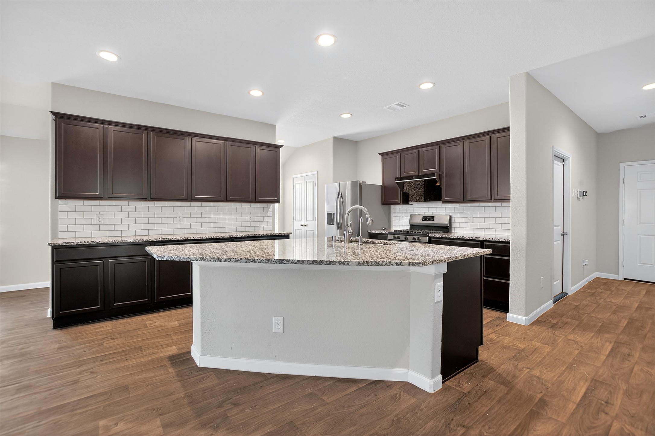 3310 Sumac Drive Katy, TX 77494 - Photo 7 of 45 a kitchen with stainless steel appliances granite countertop a stove top oven a sink and a microwave