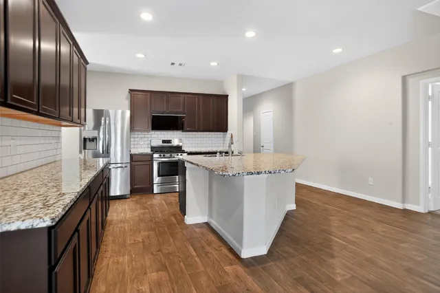 a kitchen with a sink microwave and refrigerator