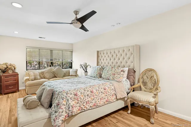 a bedroom with a bed and a chair