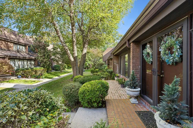 a view of a house with backyard sitting area and garden