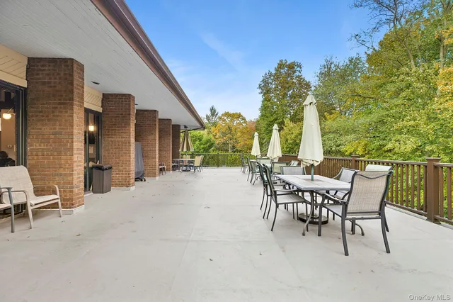 a view of a patio with a table and chairs