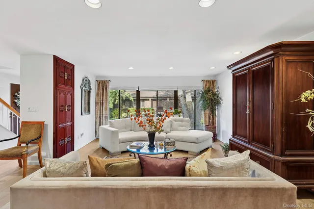 a living room with furniture and large windows