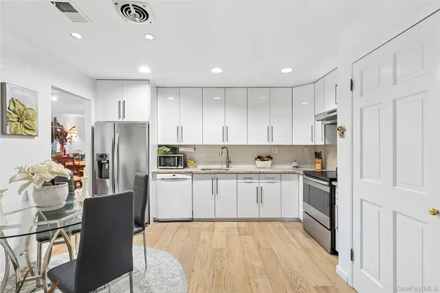 a kitchen with stainless steel appliances granite countertop a refrigerator sink and cabinets