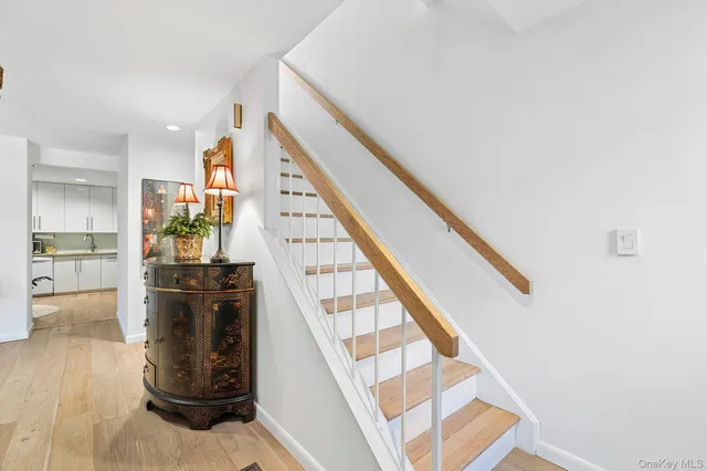 a view of entryway and hall with wooden floor