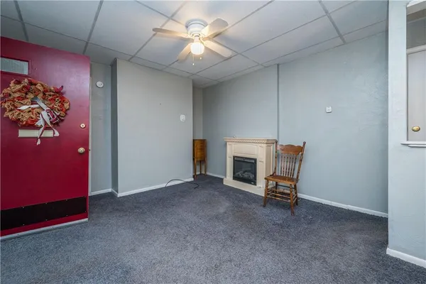 a view of a livingroom with furniture and a ceiling fan