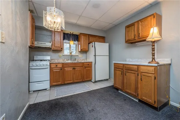 a kitchen with cabinets a window and stainless steel appliances