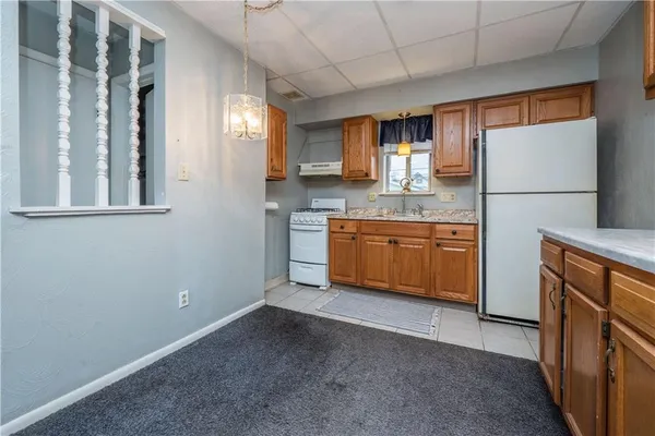 a kitchen with stainless steel appliances a sink stove and cabinets
