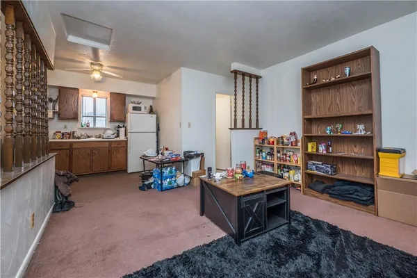 a living room with furniture and a kitchen area