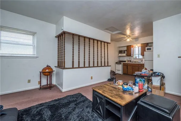 a reading room with furniture and rug