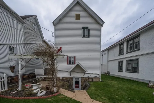 a view of a house with a yard and lawn chairs